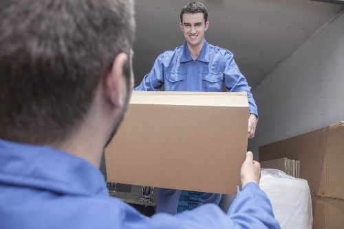 Removal team handling a move in an Acton residential street