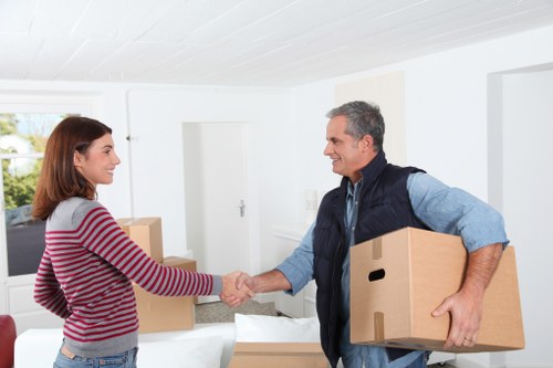 Loading household furniture into a removals van in Acton