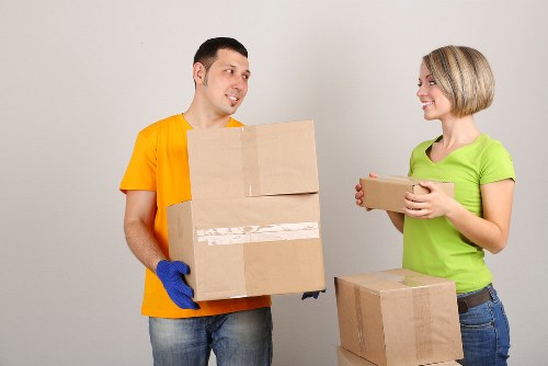 Removal van and moving team navigating an Acton street